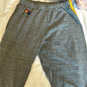 Aviator Nation sweatpants with rainbow stripe on side.